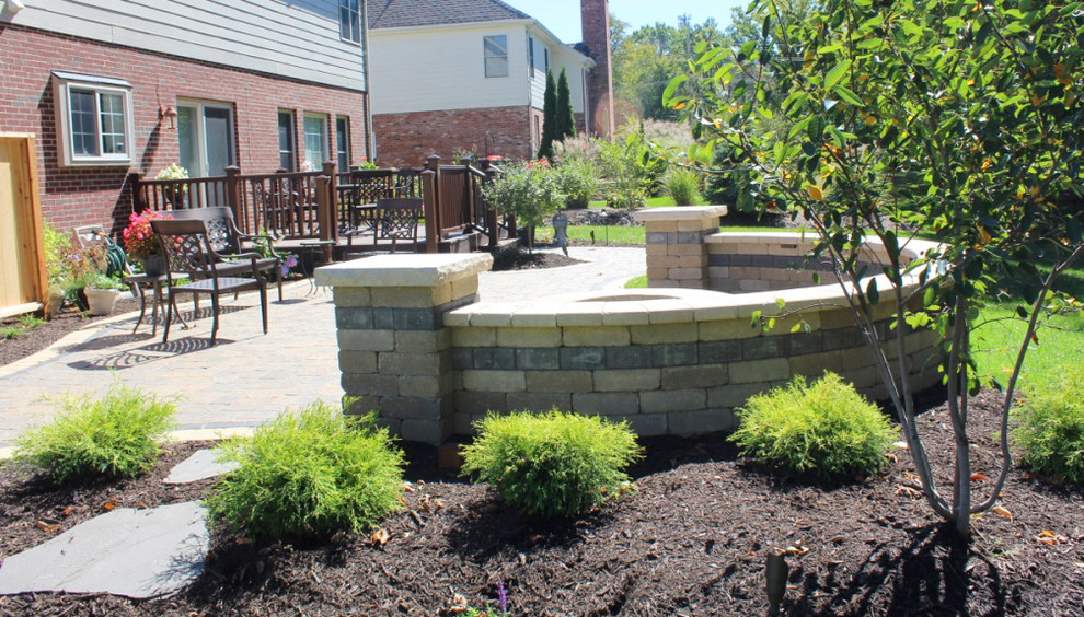 Inspiration for a mid-sized traditional backyard full sun garden in Indianapolis with a fire feature and brick pavers.
