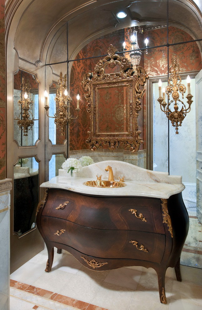 Design ideas for a small traditional powder room in Dallas with a drop-in sink, furniture-like cabinets, dark wood cabinets, onyx benchtops, a one-piece toilet, white tile, orange tile, orange walls, marble floors, mirror tile and beige benchtops.