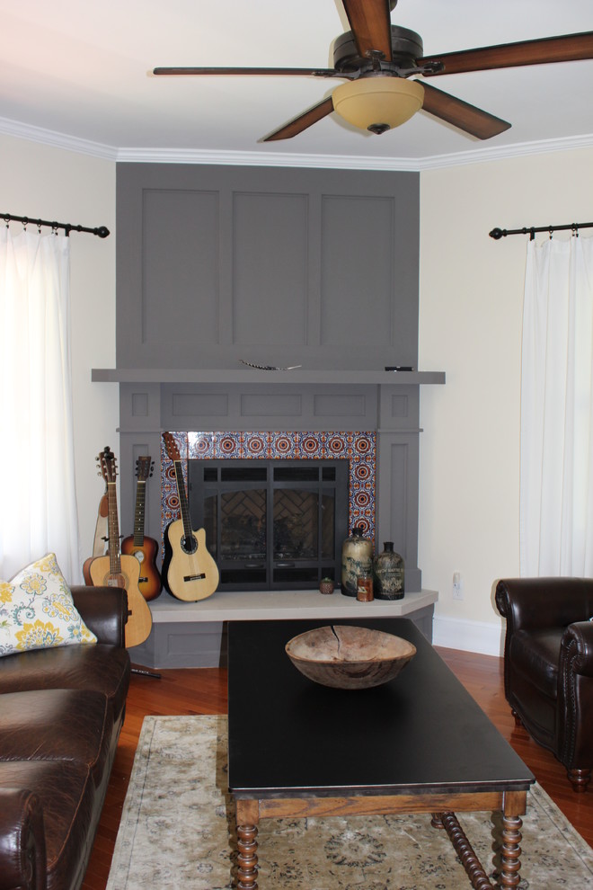 Mid-sized traditional formal enclosed living room in Other with beige walls, medium hardwood floors, a standard fireplace and a tile fireplace surround.