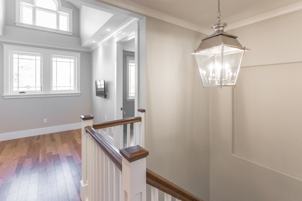 Hallway - mid-sized traditional medium tone wood floor and brown floor hallway idea with white walls