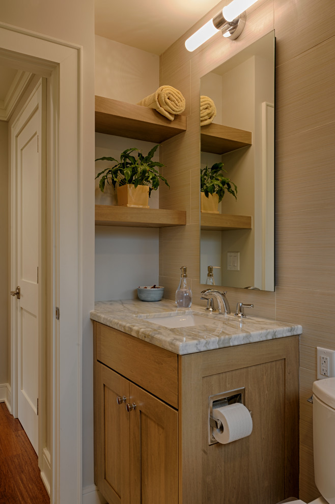 Photo of a small arts and crafts bathroom in Raleigh with shaker cabinets, medium wood cabinets, an open shower, a two-piece toilet, beige tile, porcelain tile, grey walls, porcelain floors, an undermount sink, quartzite benchtops, beige floor and a sliding shower screen.