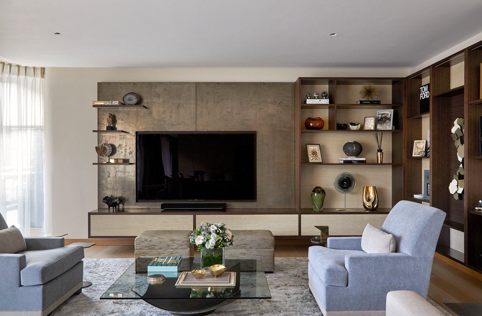 This is an example of a contemporary living room in London with white walls, medium hardwood floors, a wall-mounted tv and brown floor.