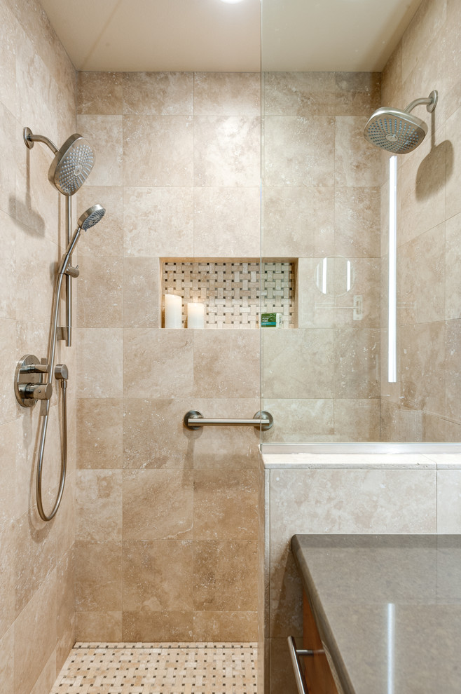 This is an example of a small traditional master bathroom in Portland with raised-panel cabinets, medium wood cabinets, a curbless shower, a wall-mount toilet, beige tile, travertine, beige walls, travertine floors, an undermount sink, engineered quartz benchtops, multi-coloured floor and a hinged shower door.