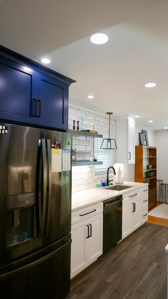 Inspiration for a mid-sized transitional galley porcelain tile and gray floor eat-in kitchen remodel with an undermount sink, shaker cabinets, white cabinets, quartz countertops, white backsplash, subway tile backsplash, black appliances, no island and white countertops