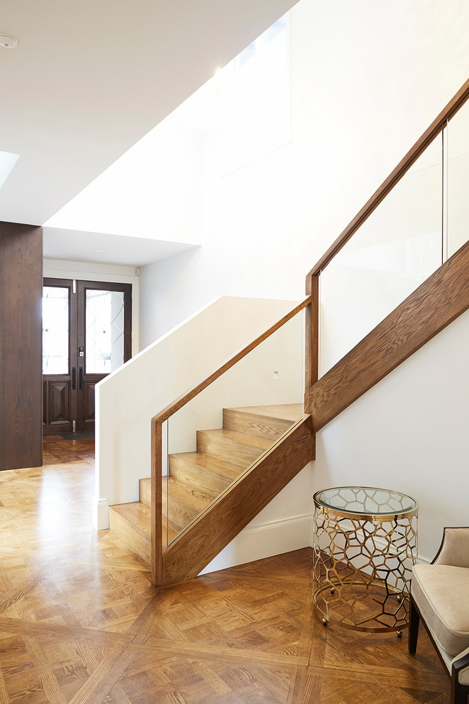 Large contemporary wood u-shaped staircase in Melbourne with wood risers and wood railing.
