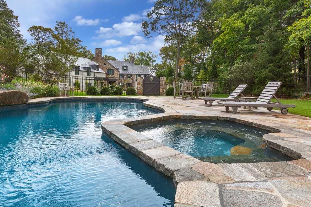 Inspiration for a large timeless backyard stone and custom-shaped aboveground hot tub remodel in New York