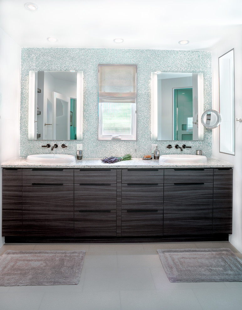 Inspiration for a large modern master bathroom in San Francisco with a curbless shower, a one-piece toilet, green tile, porcelain tile, white walls, porcelain floors, flat-panel cabinets, dark wood cabinets, recycled glass benchtops, a drop-in sink and grey floor.