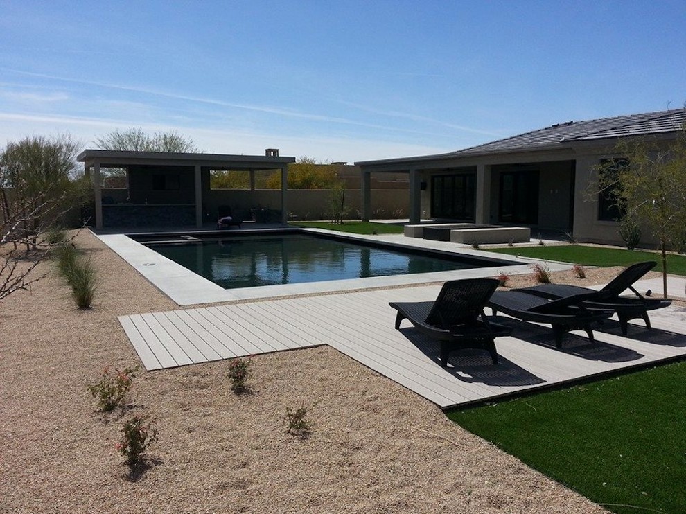 Pool fountain - large rustic backyard rectangular lap pool fountain idea in Phoenix