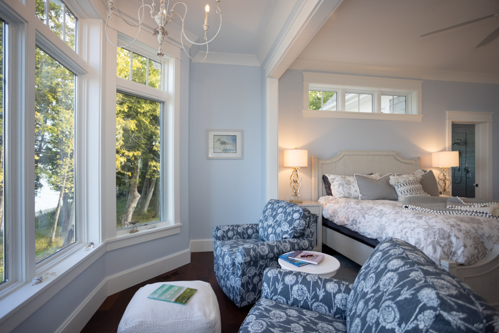 Design ideas for a classic guest bedroom in Other with blue walls, dark hardwood flooring and brown floors.