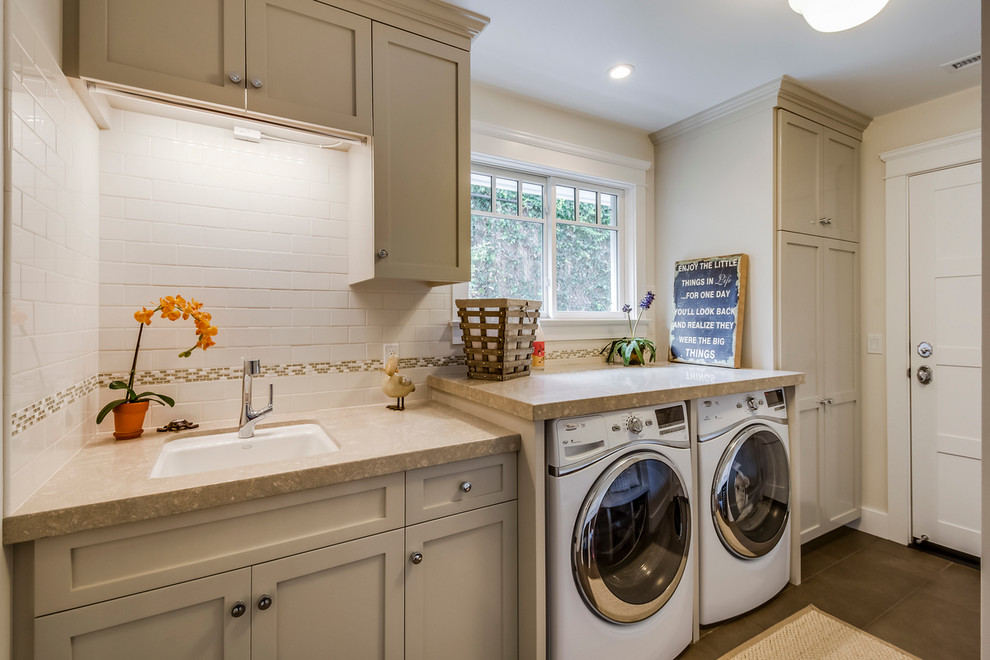 Photo of a mid-sized traditional dedicated laundry room in Los Angeles with an undermount sink, shaker cabinets, grey cabinets, beige walls, a side-by-side washer and dryer, grey floor and beige benchtop.