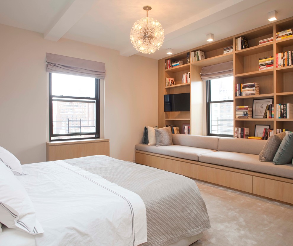 Contemporary bedroom in New York with beige walls and carpet.