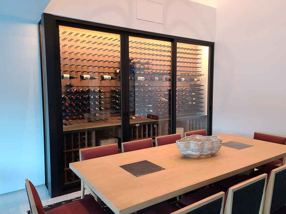 Small contemporary wine cellar in Los Angeles with display racks.