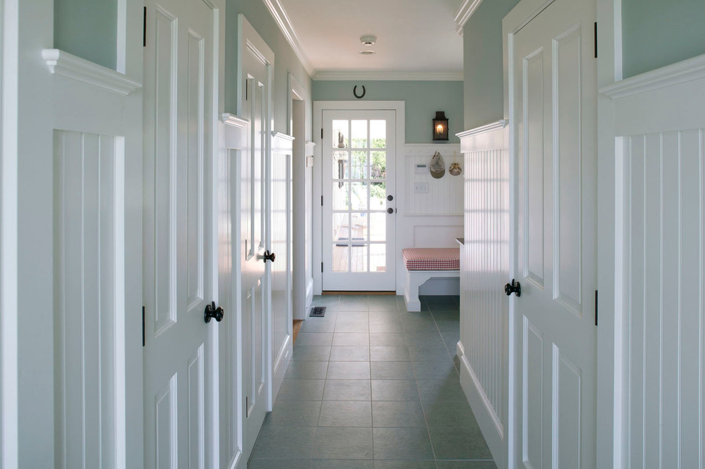 This is an example of a mid-sized traditional hallway in Boston with multi-coloured walls, ceramic floors and blue floor.