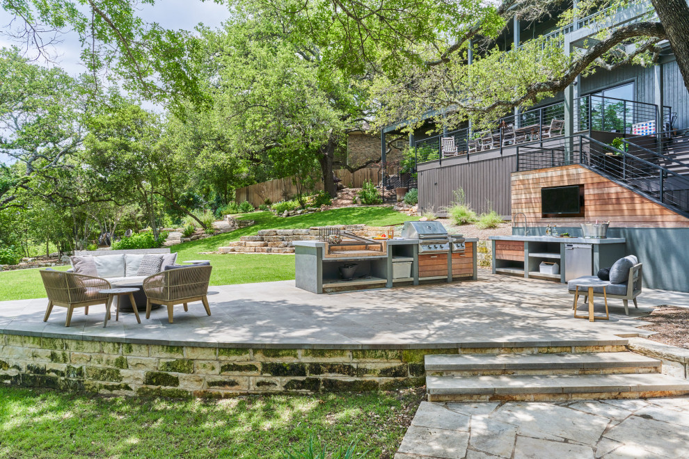 Inspiration for a mid-sized contemporary backyard concrete paver patio kitchen remodel in Austin with no cover