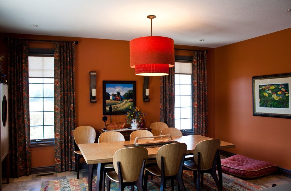 Photo of a small contemporary separate dining room in Wichita with orange walls and ceramic floors.
