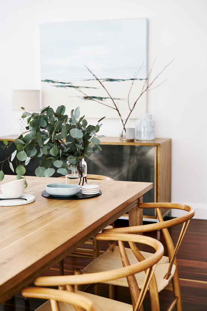 Mid-sized scandinavian open plan dining in Sydney with white walls, dark hardwood floors, no fireplace and brown floor.