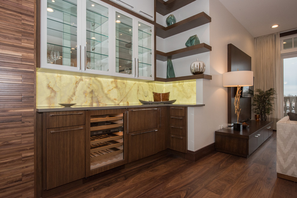 Inspiration for a midcentury l-shaped wet bar in Other with no sink, flat-panel cabinets, brown cabinets, quartz benchtops, yellow splashback, marble splashback, medium hardwood floors and brown floor.