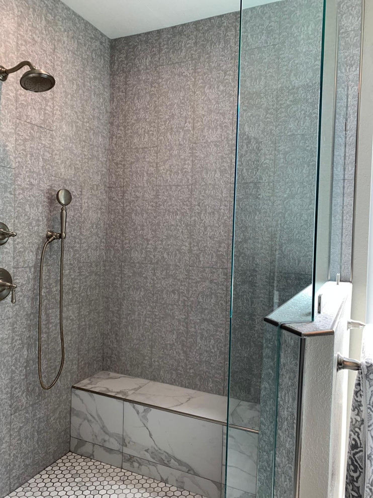 This is an example of a large contemporary master bathroom in Orange County with recessed-panel cabinets, grey cabinets, a freestanding tub, a corner shower, a one-piece toilet, gray tile, slate, green walls, marble floors, an undermount sink, marble benchtops, grey floor, a hinged shower door, yellow benchtops, a niche, a shower seat, a double vanity and a built-in vanity.