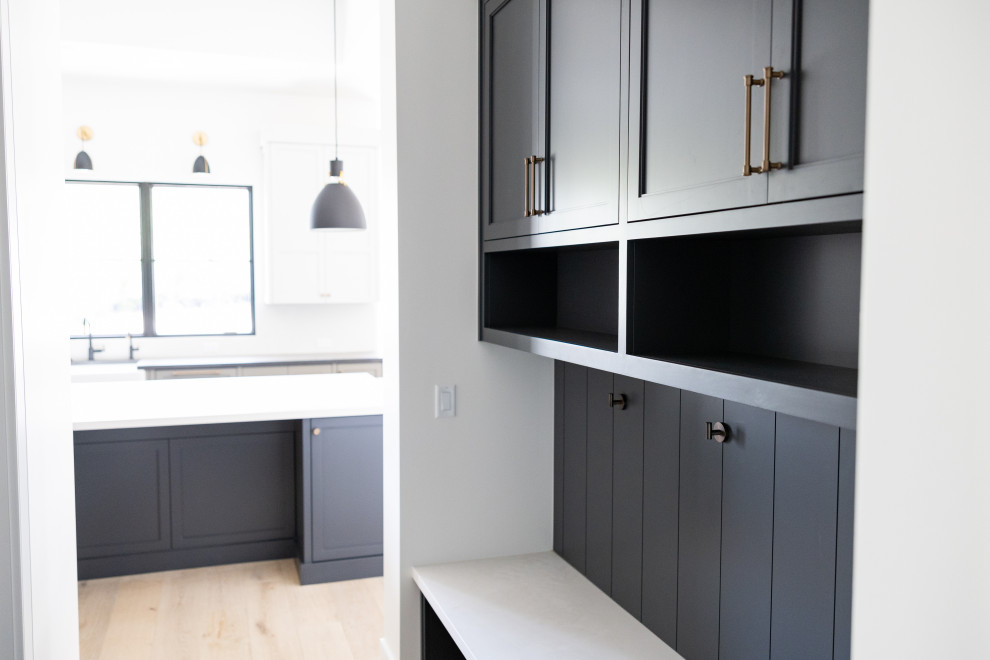 Example of a large transitional galley open concept kitchen design in Phoenix with an integrated sink, recessed-panel cabinets, gray cabinets, marble countertops, white backsplash, marble backsplash, paneled appliances, an island and white countertops