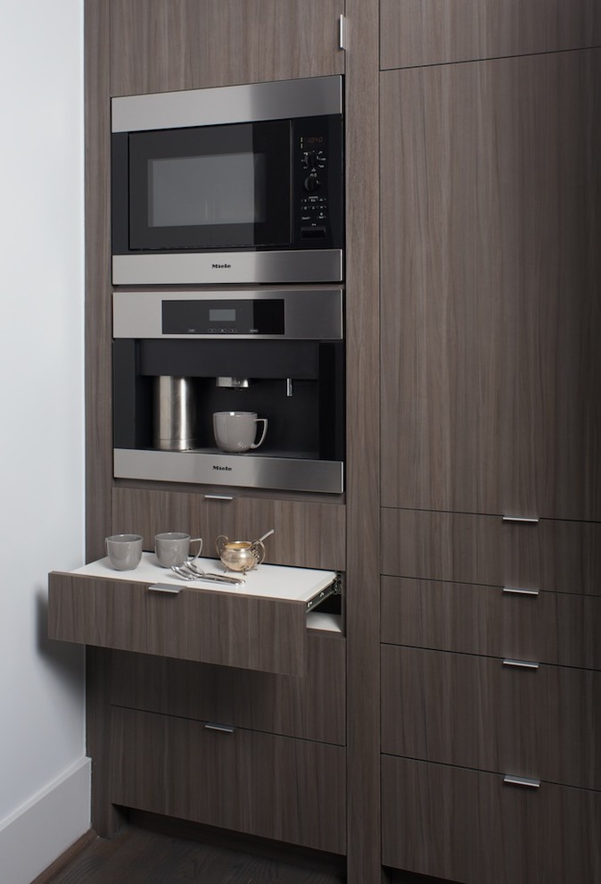 Example of a transitional galley open concept kitchen design in Denver with flat-panel cabinets and brown cabinets