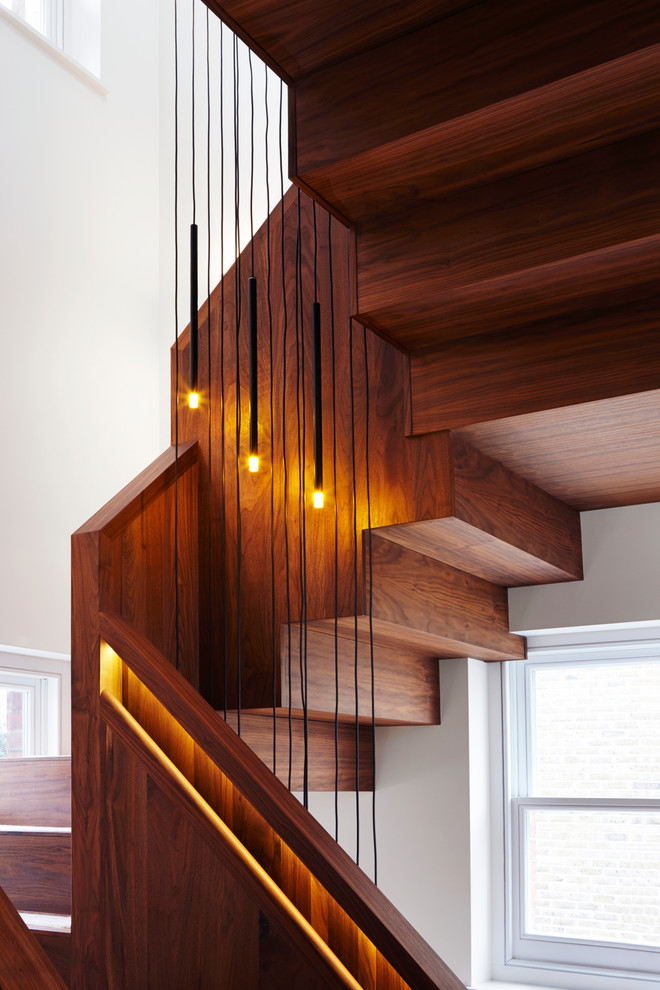 Design ideas for a mid-sized modern wood straight staircase in London with wood risers.