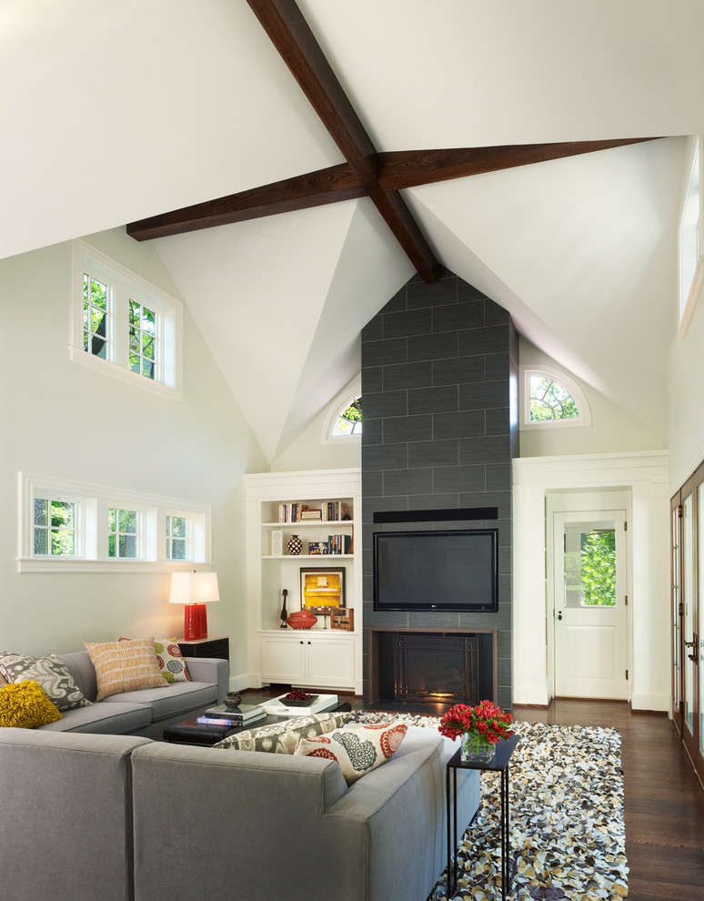 Inspiration for a contemporary loft-style family room in DC Metro with white walls, dark hardwood floors, a standard fireplace, a tile fireplace surround and a built-in media wall.