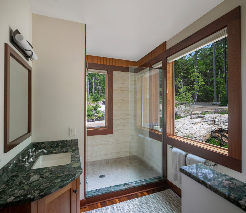 Design ideas for a mid-sized contemporary bathroom in Portland Maine with recessed-panel cabinets, medium wood cabinets, an alcove shower, beige tile, beige walls, medium hardwood floors, an undermount sink, a hinged shower door and green benchtops.