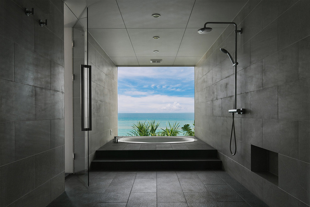Inspiration for an industrial master bathroom in Other with glass-front cabinets, a hot tub and gray tile.