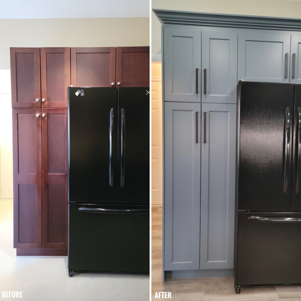 Mid-sized transitional u-shaped vinyl floor eat-in kitchen photo with an undermount sink, recessed-panel cabinets, blue cabinets, quartzite countertops, white backsplash, porcelain backsplash, black appliances, a peninsula and black countertops