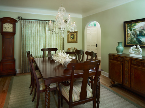 Photo of a mid-sized traditional separate dining room in Denver with green walls and light hardwood floors.