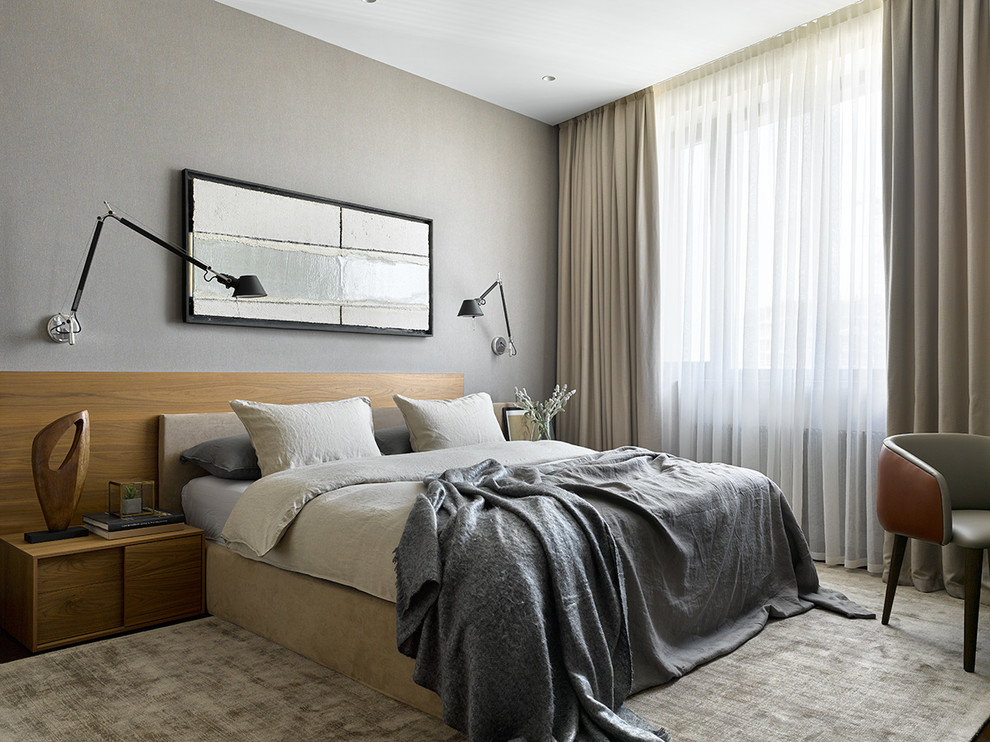This is an example of a contemporary master bedroom in Moscow with grey walls and beige floor.