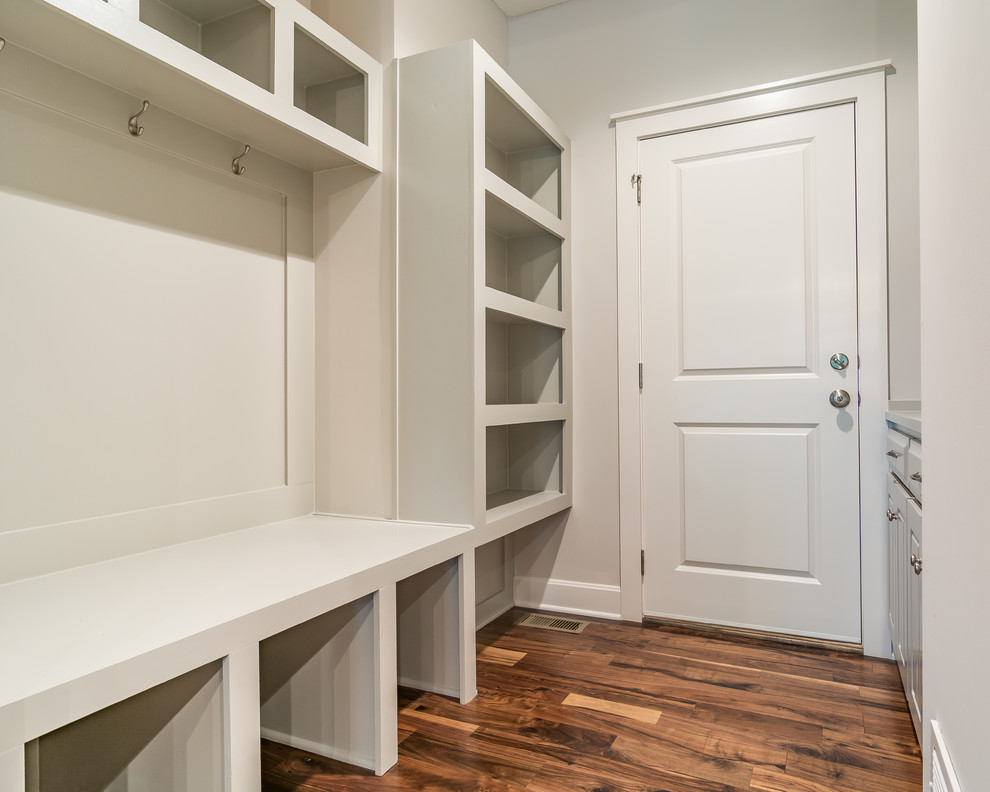 Design ideas for a mid-sized transitional galley dedicated laundry room in Kansas City with open cabinets, grey cabinets, grey walls and light hardwood floors.