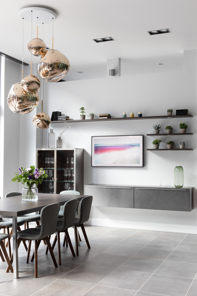 Contemporary dining room in West Midlands with white walls and grey floor.