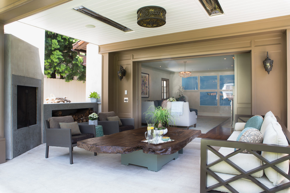 Design ideas for a transitional patio in Los Angeles with a roof extension and with fireplace.