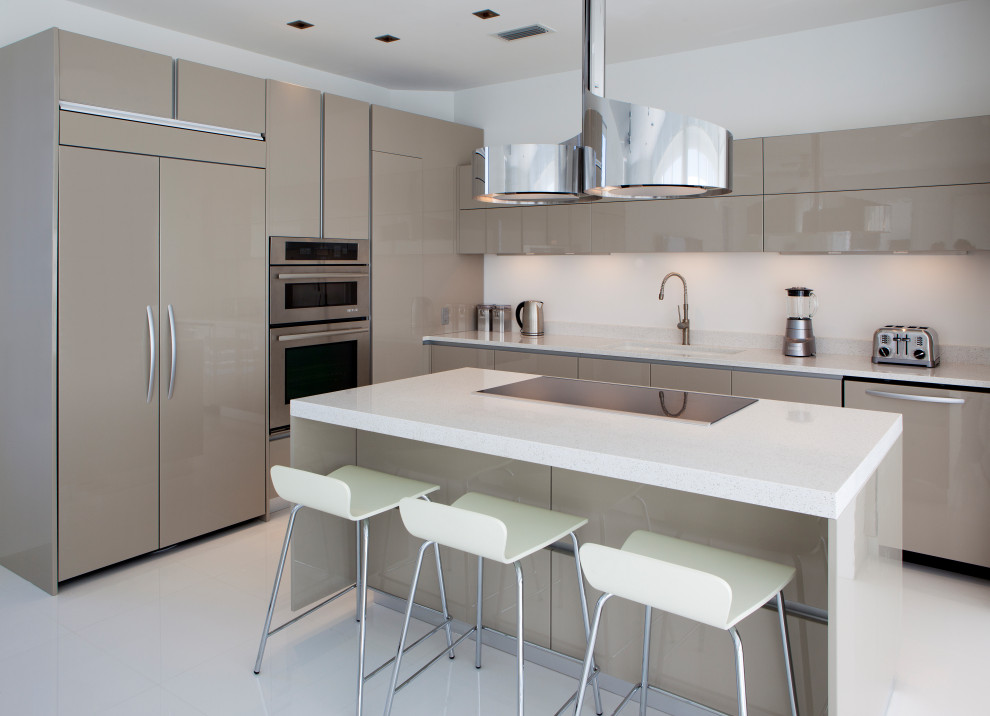 Kitchen - mid-sized contemporary l-shaped white floor kitchen idea in Tampa with an undermount sink, flat-panel cabinets, beige cabinets, paneled appliances, an island and white countertops