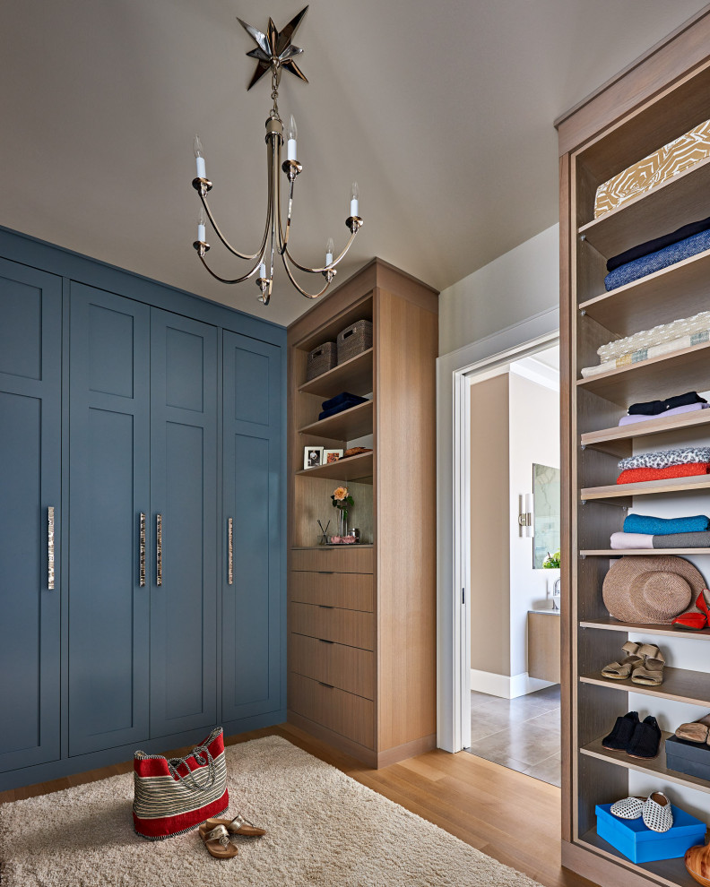 Large beach style gender-neutral light wood floor and beige floor walk-in closet photo in Wilmington with shaker cabinets and blue cabinets