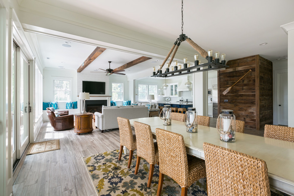 Design ideas for a beach style open plan dining in Charleston with white walls and medium hardwood floors.