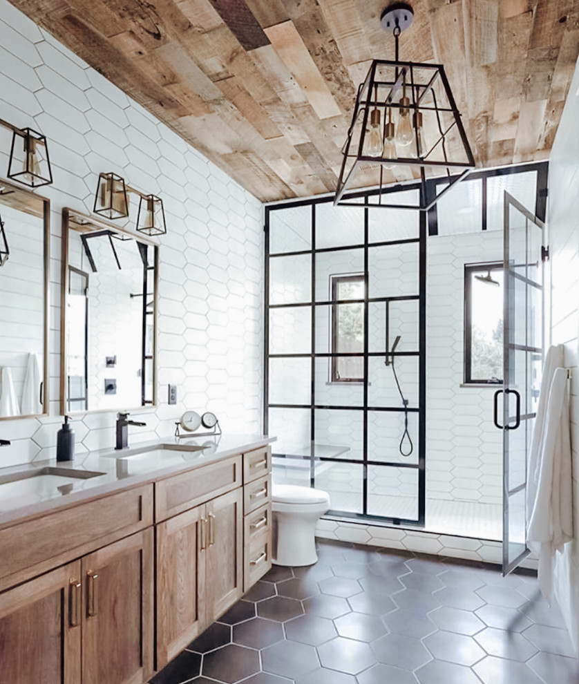 Inspiration for a large master bathroom in Dallas with medium wood cabinets, a double shower, a one-piece toilet, white tile, cement tile, white walls, ceramic floors, an undermount sink, black floor, a hinged shower door, grey benchtops, a double vanity, a built-in vanity, timber, shaker cabinets and engineered quartz benchtops.