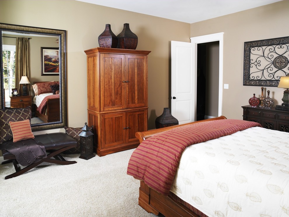 This is an example of a traditional master bedroom in Other with beige walls and carpet.