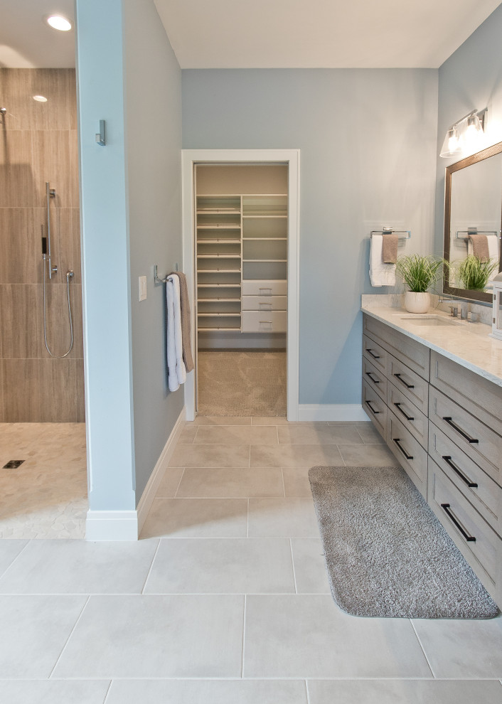 Design ideas for a transitional master bathroom with recessed-panel cabinets, beige cabinets, a corner shower, blue walls, pebble tile floors, an undermount sink, engineered quartz benchtops, beige floor, an open shower, beige benchtops, a shower seat, a double vanity and a built-in vanity.
