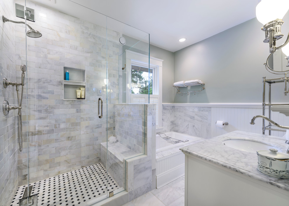 Photo of a mid-sized traditional master bathroom in Cincinnati with an undermount sink, recessed-panel cabinets, white cabinets, marble benchtops, a drop-in tub, a corner shower, a two-piece toilet, white tile, subway tile, green walls and marble floors.
