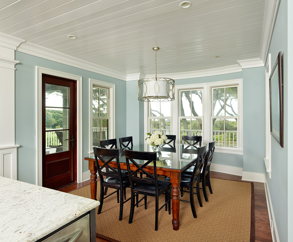 Tropical kitchen/dining combo in Charleston with blue walls and dark hardwood floors.