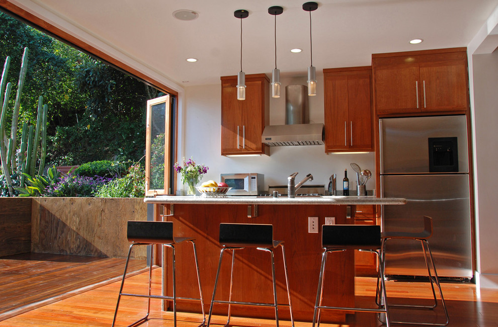 Contemporary galley kitchen in San Francisco with medium wood cabinets and stainless steel appliances.