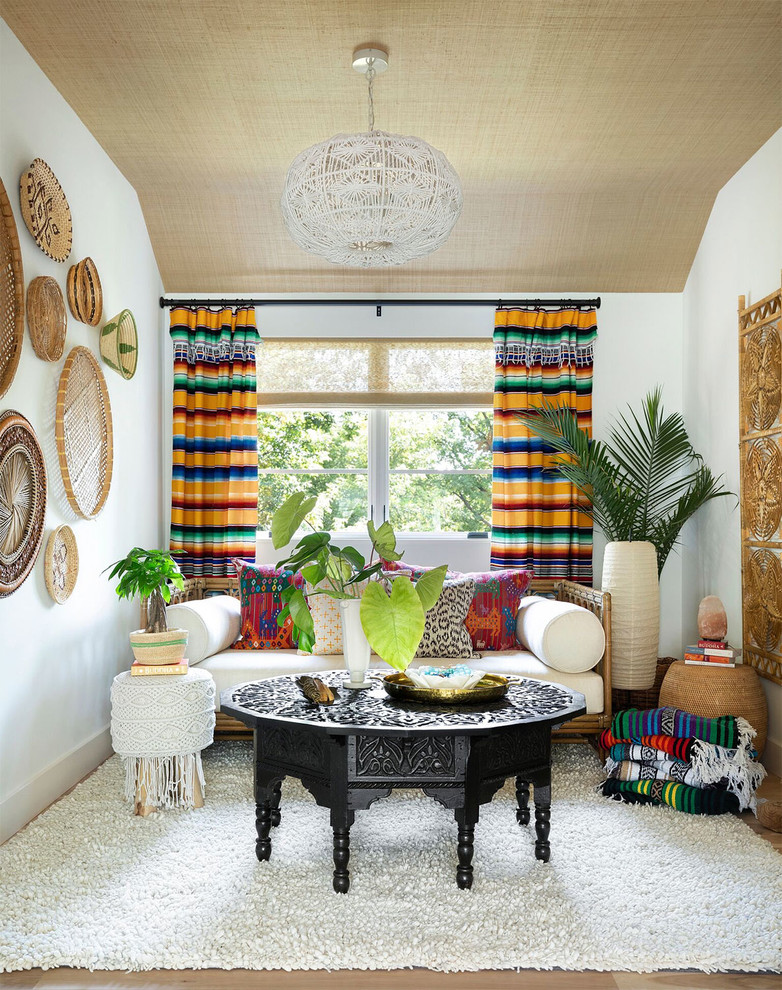 Inspiration for an eclectic light wood floor family room remodel in Minneapolis with white walls and no fireplace