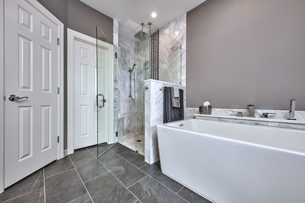 Inspiration for a mid-sized transitional master bathroom in Austin with a freestanding tub, a corner shower, black and white tile, marble, grey walls, porcelain floors, marble benchtops, grey floor, a hinged shower door, an undermount sink and yellow benchtops.