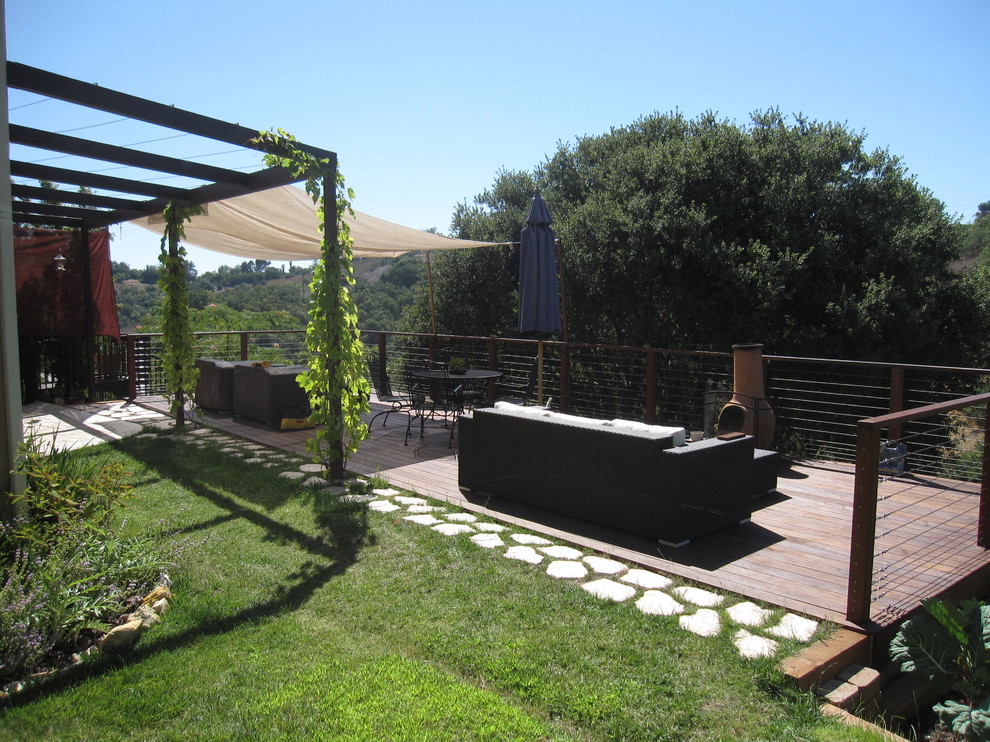 Inspiration for a large contemporary backyard deck in Los Angeles with a pergola.