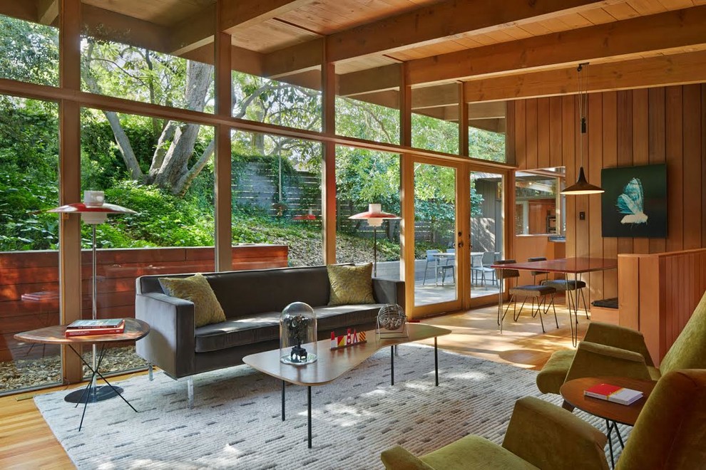 Photo of a small midcentury open concept living room in San Francisco with light hardwood floors.