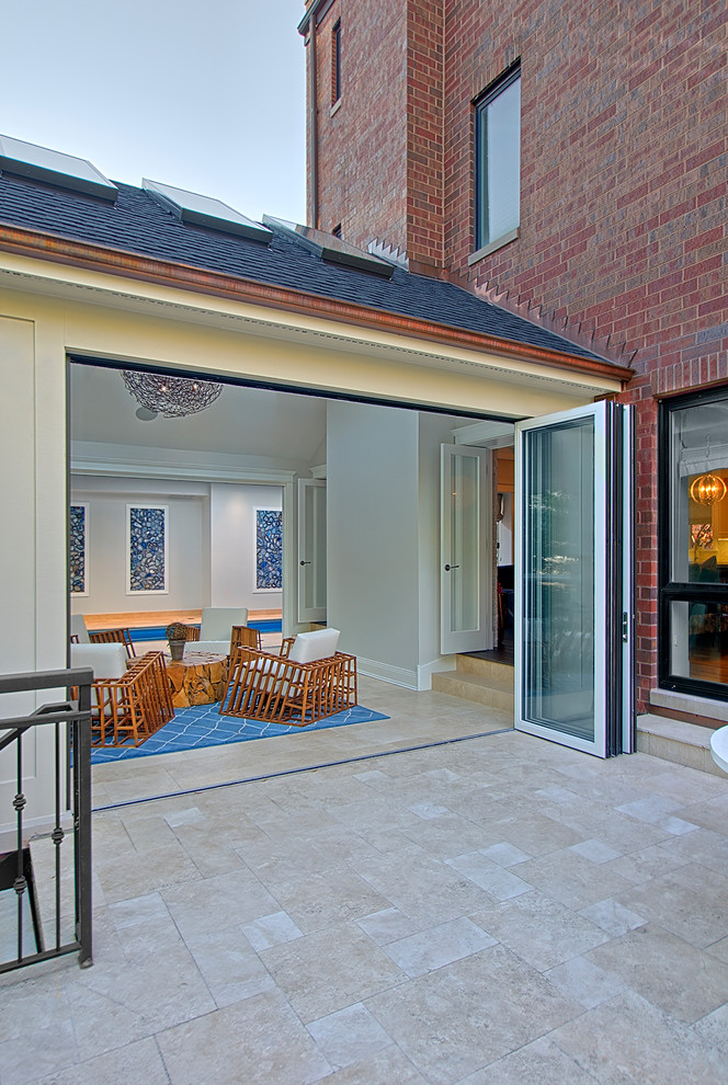 This is an example of a large transitional side yard patio in Chicago with tile and no cover.