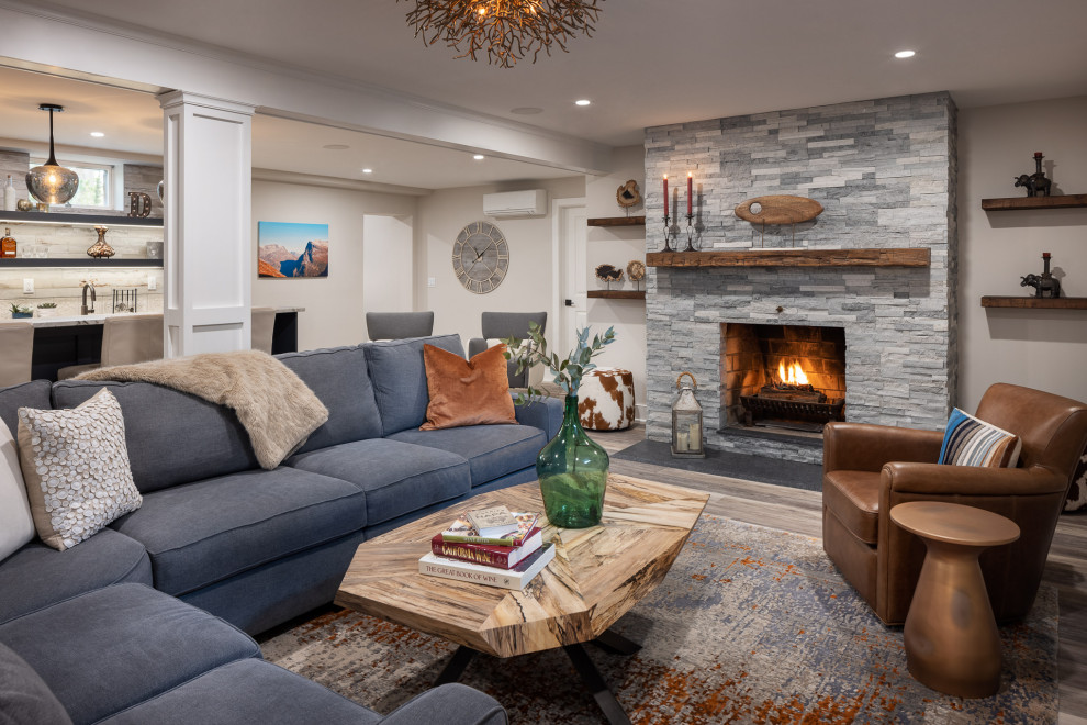 Large eclectic underground vinyl floor, gray floor and shiplap wall basement photo in New York with a bar, beige walls, a standard fireplace and a stacked stone fireplace