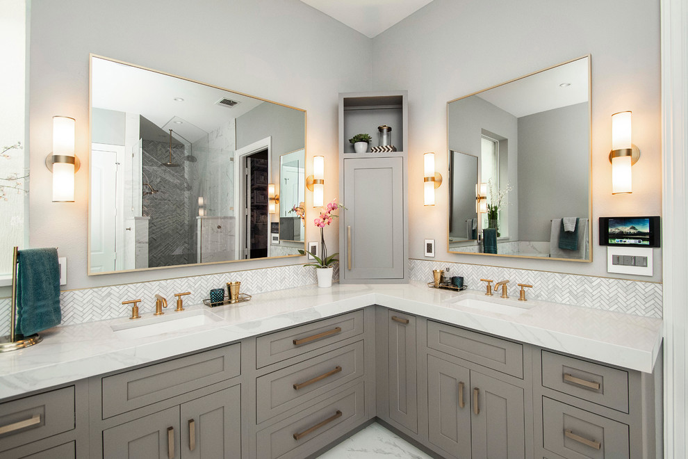 This is an example of a mid-sized modern master bathroom in Dallas with raised-panel cabinets, grey cabinets, a freestanding tub, white tile, porcelain tile, engineered quartz benchtops, white benchtops, a double shower, a two-piece toilet, grey walls, porcelain floors, an undermount sink, white floor and an open shower.